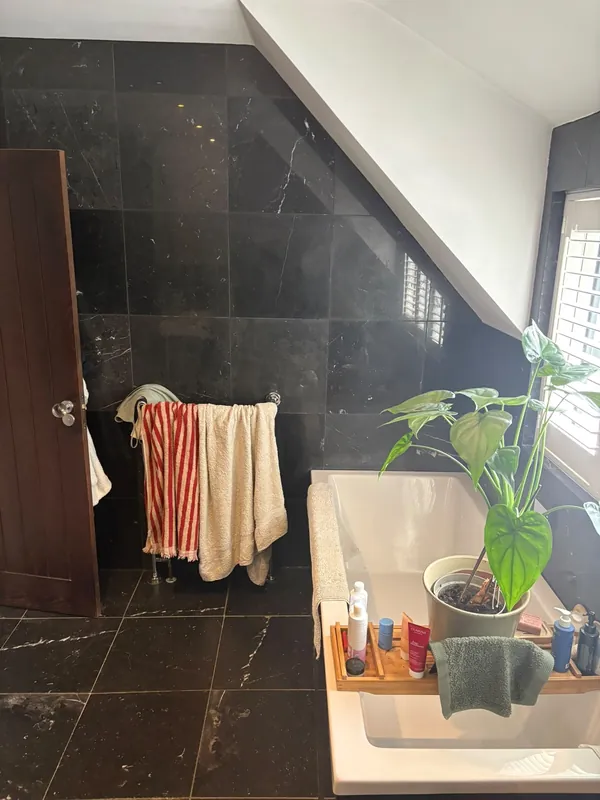 The old bath and black tiles